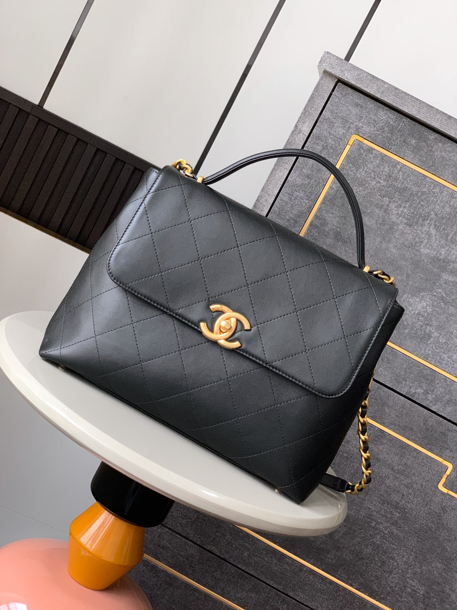 Chanel Maxi flap bag with top handle, Calfskin & gold-tone metal,