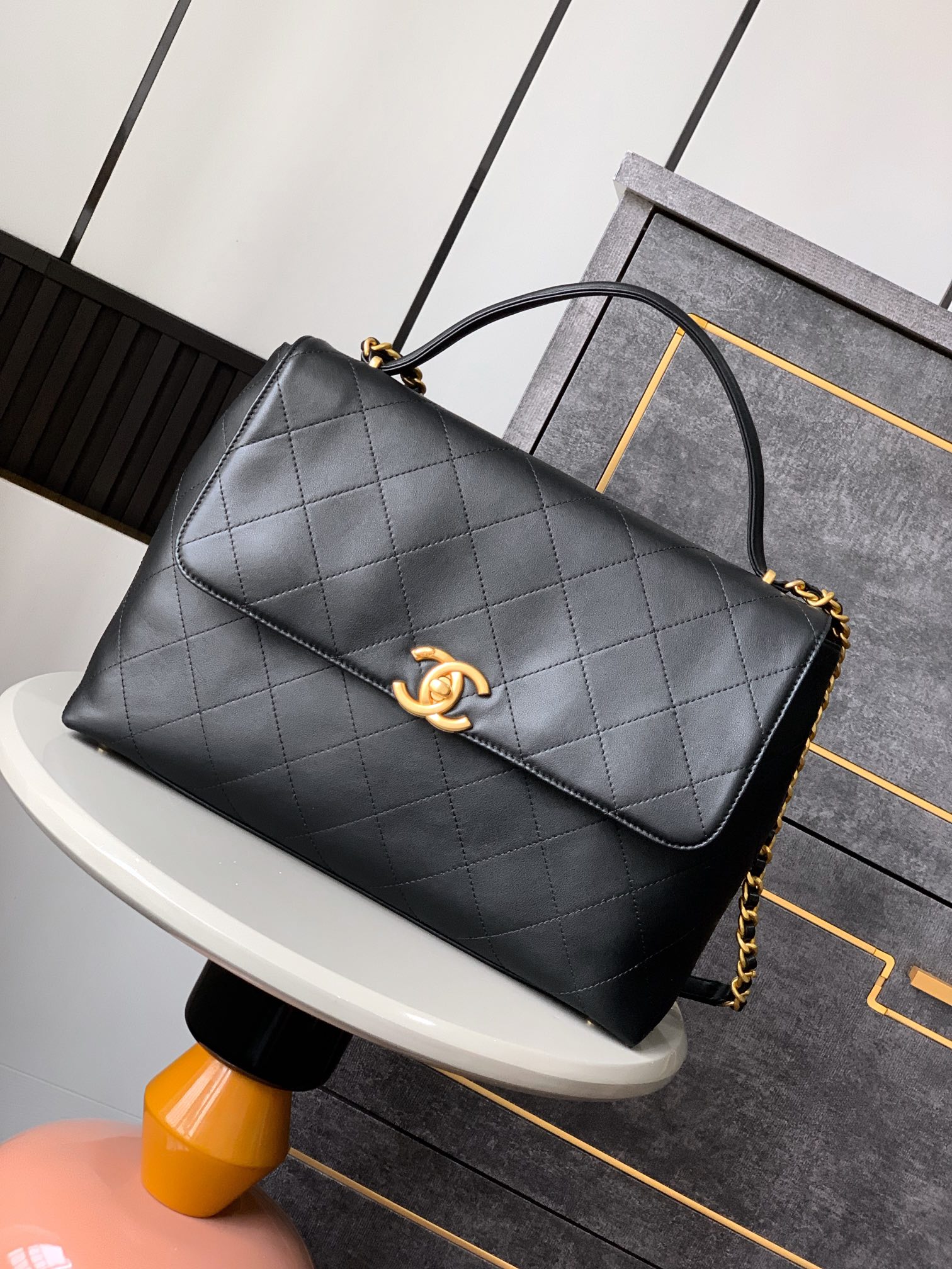 Chanel Maxi flap bag with top handle, Calfskin & gold-tone metal,black