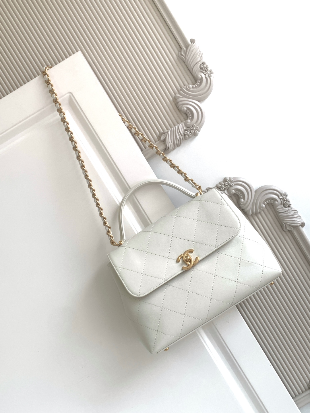 Chanel Maxi flap bag with top handle, Calfskin & gold-tone metal, white